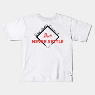 Slow down if you must But NEVER SETTLE Kids T-Shirt